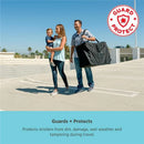 Black travel bag for strollers held by a man, with a woman carrying a child, demonstrating protection during travel.