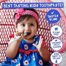 A toddler with a pink headband smiles while holding a toothbrush and showing a tube of raspberry-flavored toothpaste.