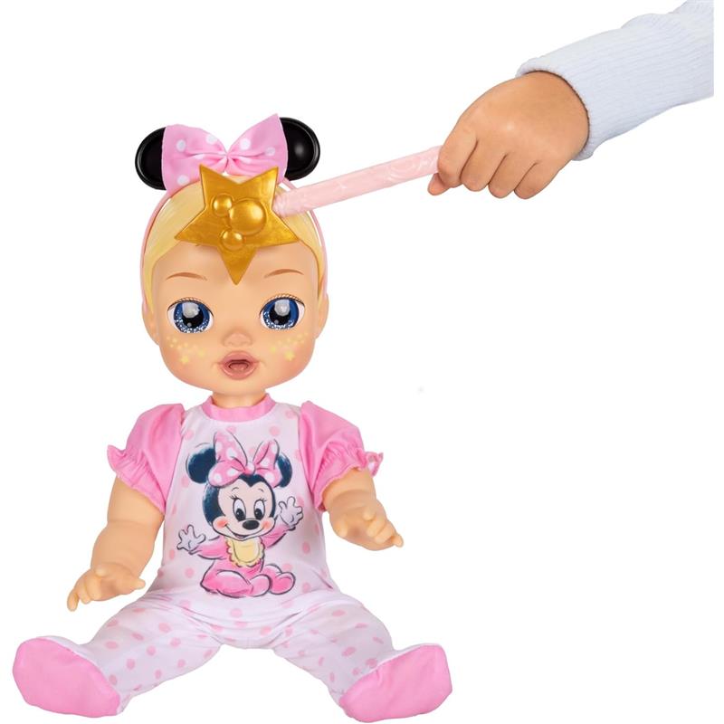 Interactive 13-inch blonde-haired baby doll wearing a pink outfit with Minnie Mouse design, being playfully waved at with a star wand.