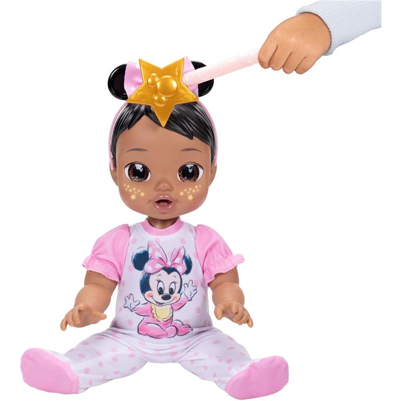 13-inch interactive baby doll with brown hair, wearing a Minnie Mouse onesie, with a star-shaped accessory on its head.