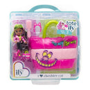 2-inch mini doll with green hair wearing a pink and black outfit, holding a pink tote bag featuring the Cheshire Cat design.