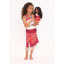 Young girl dressed as Moana holds a large singing Moana doll, both wearing colorful outfits.