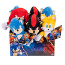 Plush figures from the Sonic 3 movie, including Sonic, Knuckles, Shadow, and Tails, in a display box.