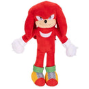 Red plush toy of Knuckles from the Sonic the Hedgehog franchise, featuring a smiling expression and colorful footwear.
