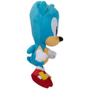 Blue Sonic plush toy standing upright, featuring a characteristic spiky head, white gloves, and red shoes with yellow buckles.