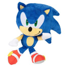 Sonic the Hedgehog plush toy, featuring blue fur, green eyes, and red shoes, striking a playful pose.