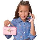 Child holding a pink wristlet phone with a floral shirt, smiling while using the phone on her ear.