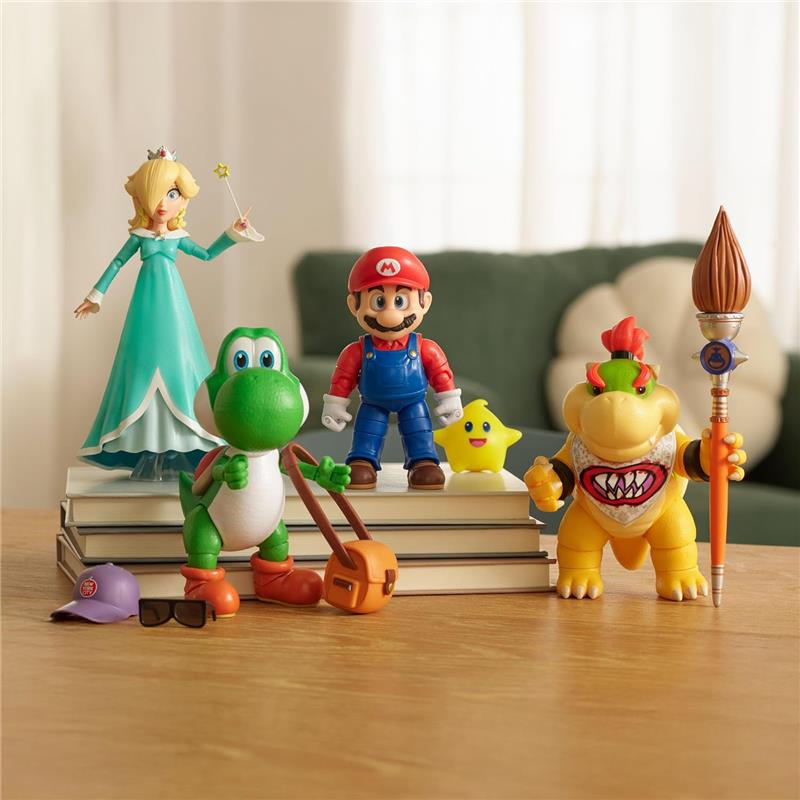 5-inch action figures of Mario, Rosalina, Yoshi, Bowser, and a yellow glow-in-the-dark Luma Star on stacked books.