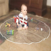 Baby playing on a Jeep Mealtime & Playtime Mat, surrounded by toys and scattered snacks, with a joyful expression.