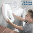 A child holds a pink Jool Baby potty training seat, preparing to attach it to a toilet; a hook for storage is shown.