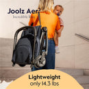 Joolz Aer² lightweight compact stroller in Forest Green, carried by a woman holding a child, features text highlighting its weight of 14.3 lbs.