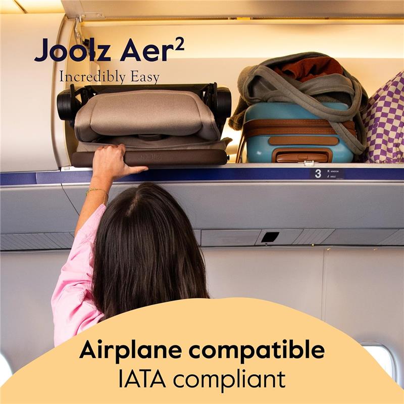 Lightweight Joolz Aer² stroller in sage green stored in an overhead airplane compartment, with a person reaching for it.