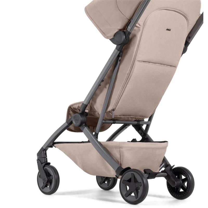 Lightweight compact stroller by Joolz in Sandy Taupe, featuring a reclining seat and a storage basket underneath.