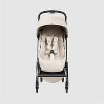 Lightweight compact Joolz Aer² stroller in calming beige, showing an ergonomic seat with harness and sun canopy.
