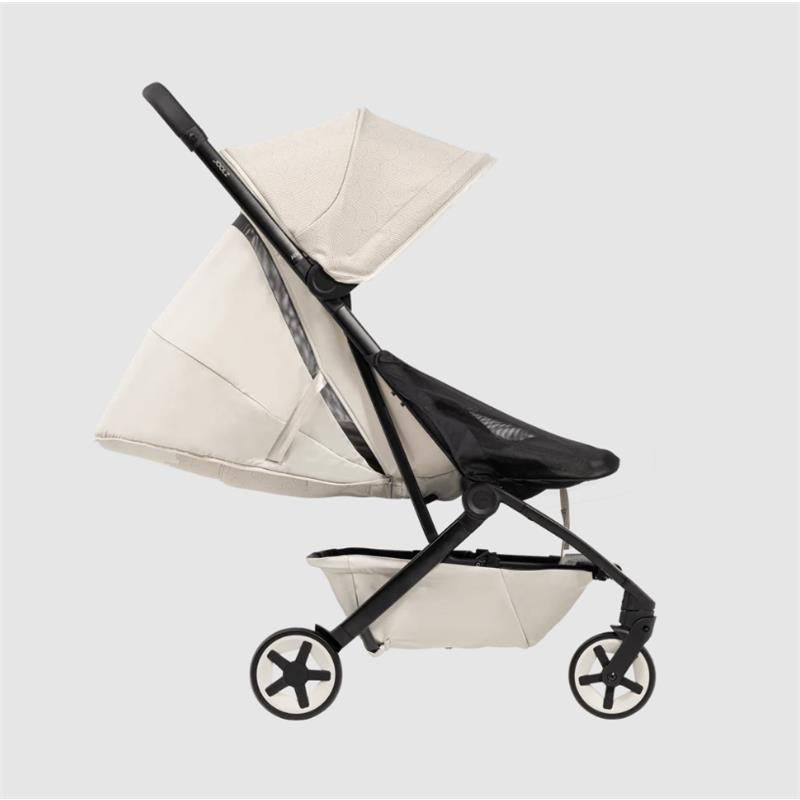 Lightweight compact stroller in calming beige with a black mesh seat and canopy, showcasing a sleek design and star-pattern wheels.