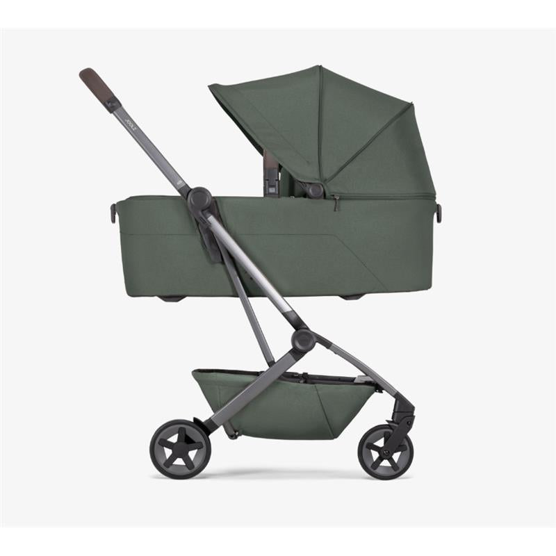Joolz Aer2 Bassinet in Forest Green, featuring a sleek design with a canopy and a lower storage basket.
