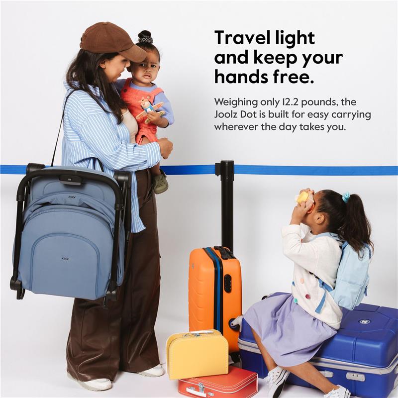 Joolz Dot travel stroller in lagoon blue is carried by a woman, while children play with luggage in a travel setting.