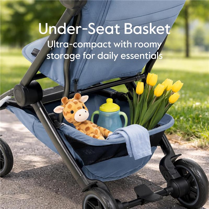 Under-seat basket of Joolz Dot stroller with a stuffed giraffe, water bottle, and yellow tulips, designed for compact storage.