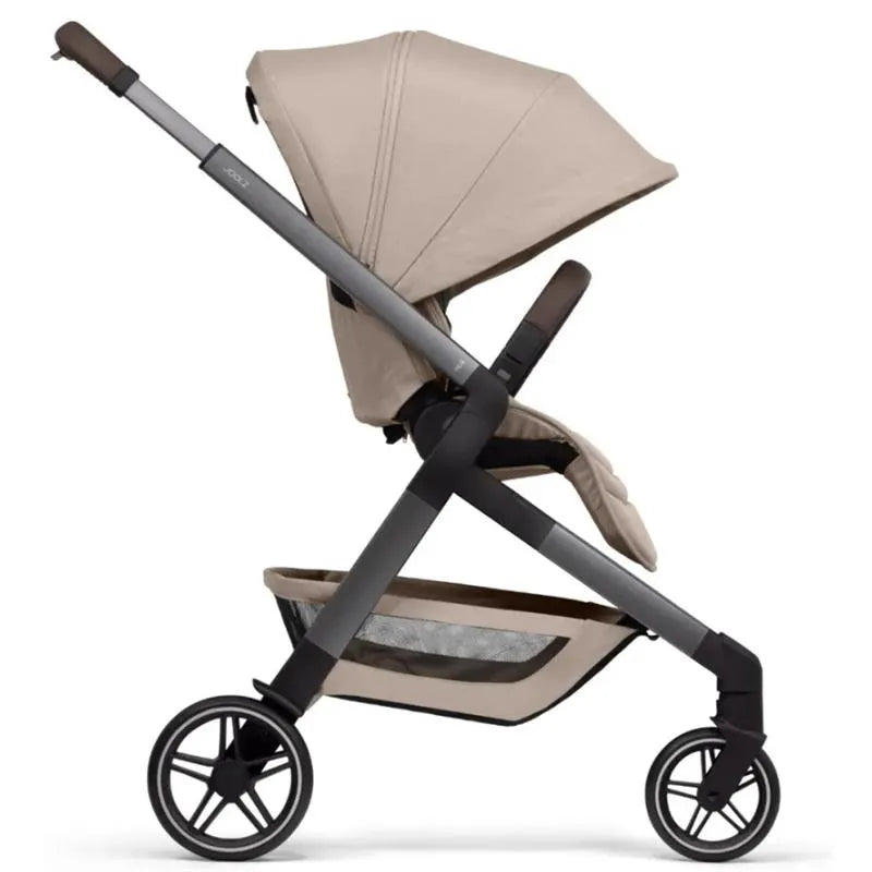 Lightweight Joolz Hub² Compact Stroller in sandy taupe, featuring a reclined seat, adjustable canopy, and spacious storage basket.