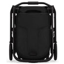 Compact Joolz Hub² stroller in Space Black, viewed from the front in a folded position, showcasing a sleek design.
