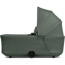 Joolz Hub2 Cot in Forest Green, featuring a soft fabric exterior and an adjustable canopy for infant comfort.