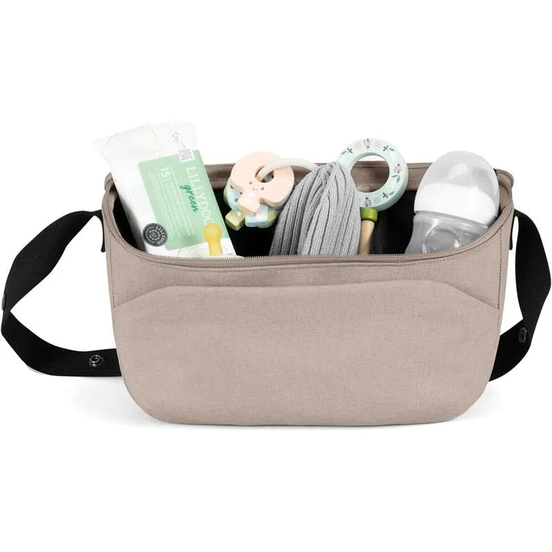 Organizer bag in sandy taupe with baby essentials like wipes, a pacifier, a teether, and a baby bottle visible inside.