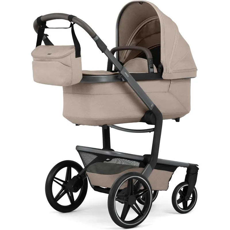 Joolz Organizer in Sandy Taupe attached to a stroller, featuring a sleek design and practical storage.