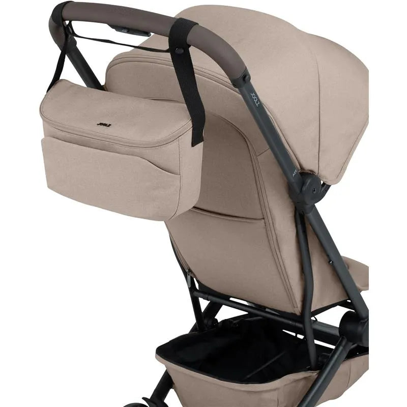 Organizer in sandy taupe attached to a stroller, featuring a zippered compartment and side pocket for convenience.