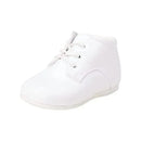 White baby boy dress shoes with lace-up straps, designed for christenings and formal occasions.