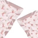 Reversible baby blanket featuring pink boots with flowers and a floral pattern, edged with satin trim.