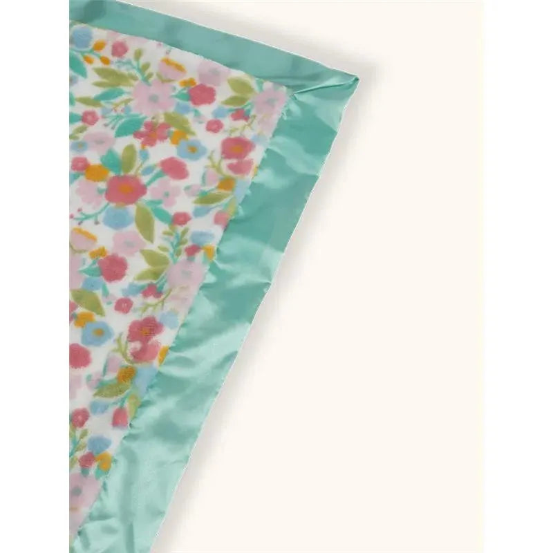 Reversible baby blanket by Jujube featuring a floral design in pink and mint green colors.