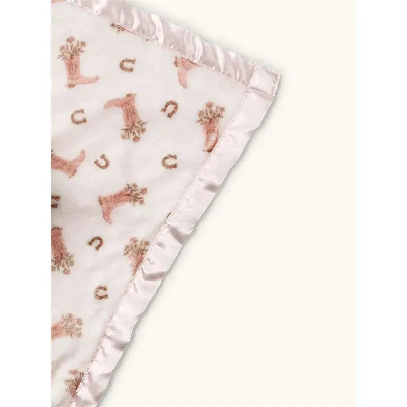 Soft security blanket featuring a playful boot and horseshoe pattern, trimmed with satin edges.