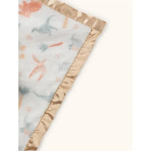 Security blanket featuring a light fabric with colorful animal prints, bordered by a soft, shiny beige satin edge.