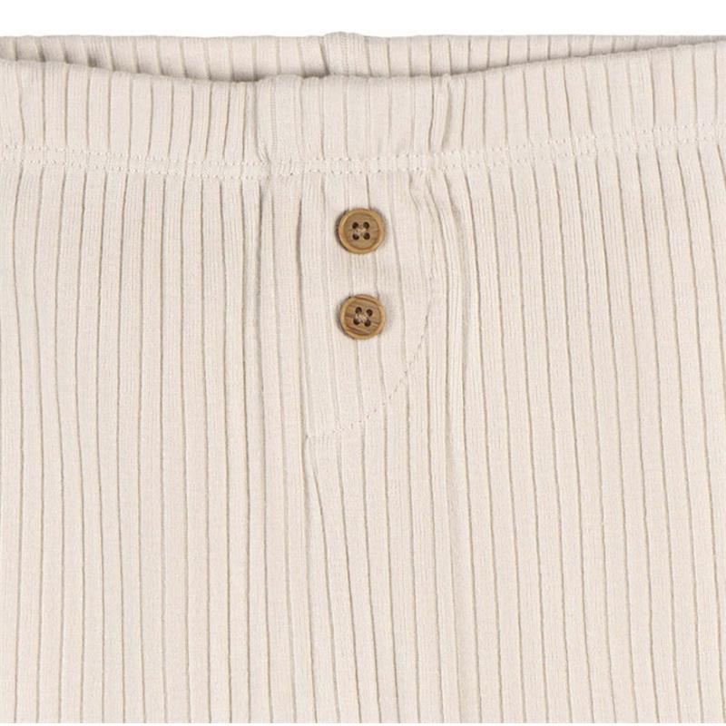 Neutral tan ribbed baby pants featuring a button closure at the waistband.