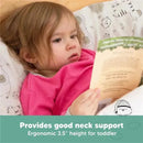 Toddler resting on a Keababies pillow while reading, with visible text highlighting good neck support and ergonomic design.