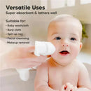 Baby smiling in a bath while a hand holds a white washcloth, with text highlighting its versatile uses.