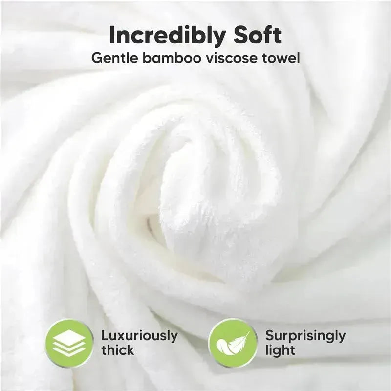 Incredibly soft, white bamboo viscose towel shown in a rolled-up position, highlighting its luxurious thickness and lightweight nature.