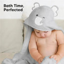 Hooded baby towel in gray with elephant design, featuring a winking face, draped over a seated baby.