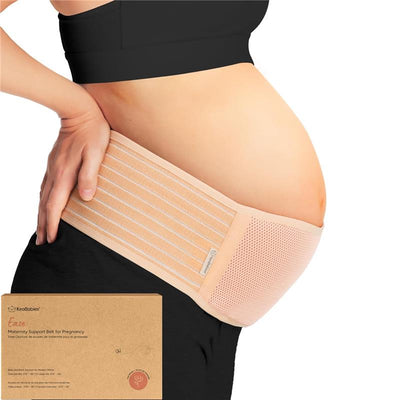 Beige maternity belly band from KeaBabies, worn around a pregnant belly for support, with packaging visible below.