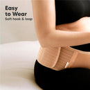 Maternity belly band in beige worn by a pregnant woman, featuring a soft hook and loop closure, emphasizing ease of wear.