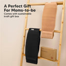 Maternity belly bands for pregnant women in black and beige displayed on a wooden rack, with a sustainable kraft gift box.