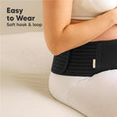 Maternity belly band in black worn by a pregnant woman, featuring soft hook and loop design for easy wearing.