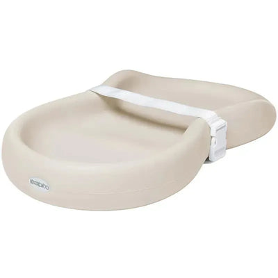 Silicone diaper changing pad in vanilla beige with a safety strap for secure use.