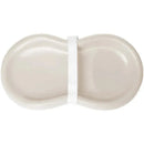 Silicone diaper pad in vanilla beige, featuring a peanut shape and a white strap for secure attachment.