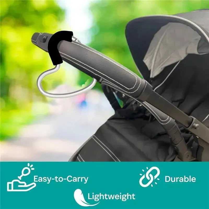 Black foam and silver aluminum Buggy Heart Hook attached to a stroller handle, promoting easy carrying, durability, and lightweight design.