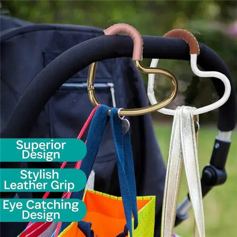 Silver aluminum heart hook with brown leather grip, hanging on a stroller handle, showcasing stylish design features.
