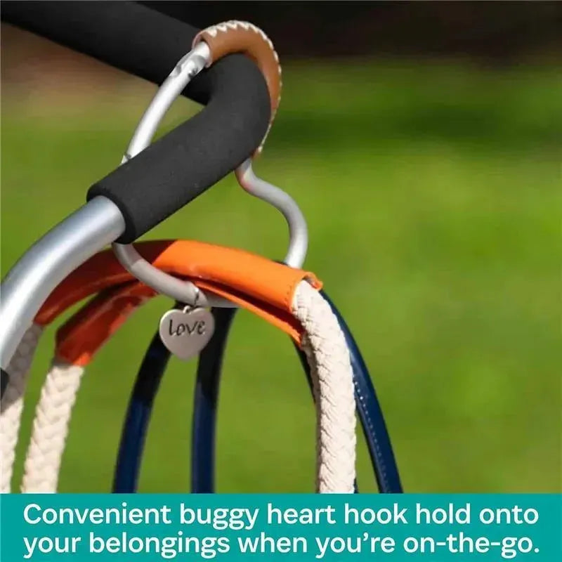 Silver aluminum buggy heart hook with brown leather grip, designed to hold belongings securely while on the go.