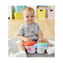 Toddler playing with Kidoozie Flash Beat Drums, colorful toy drums with buttons, sitting on a soft carpet.