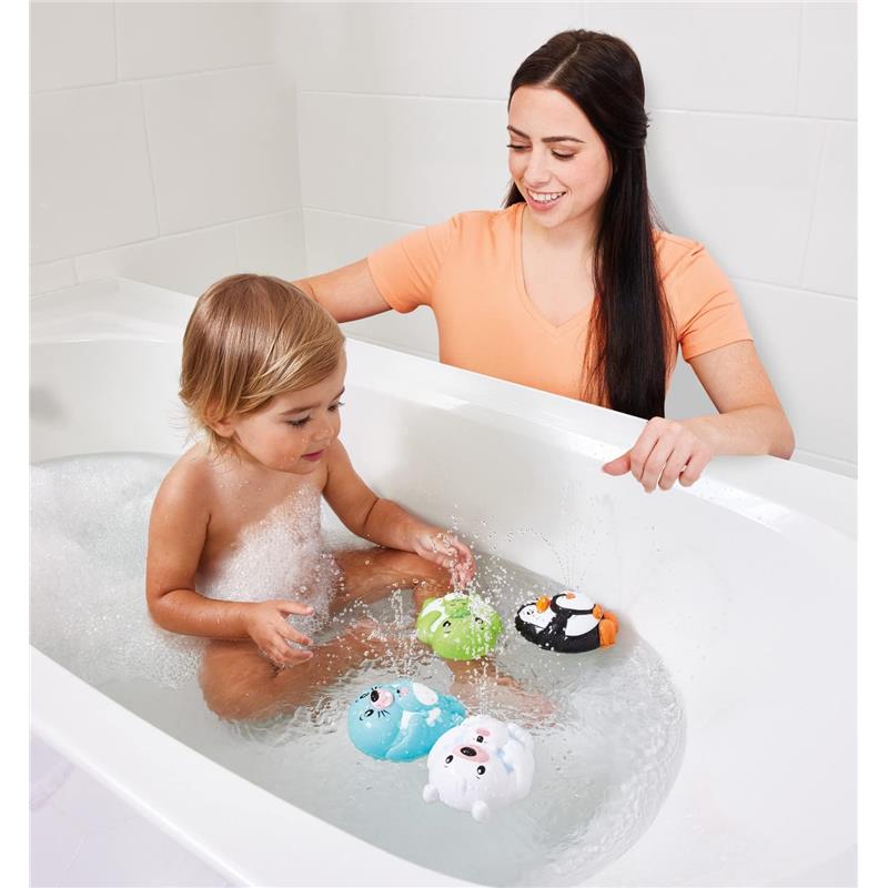 Child playing in a bathtub with colorful squirt toys, while an adult engages and smiles nearby.
