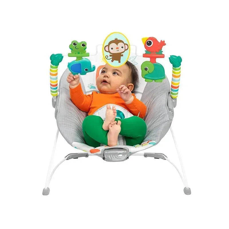 Baby in a colorful bouncer seat, surrounded by toy animals, reaching for toys with a joyful expression.
